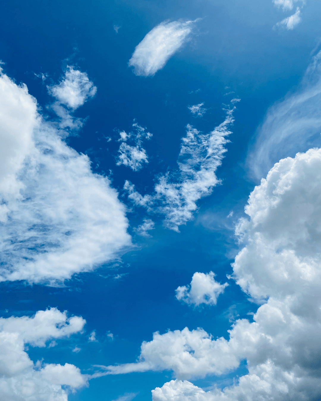 Blue sky with white clouds seen from below